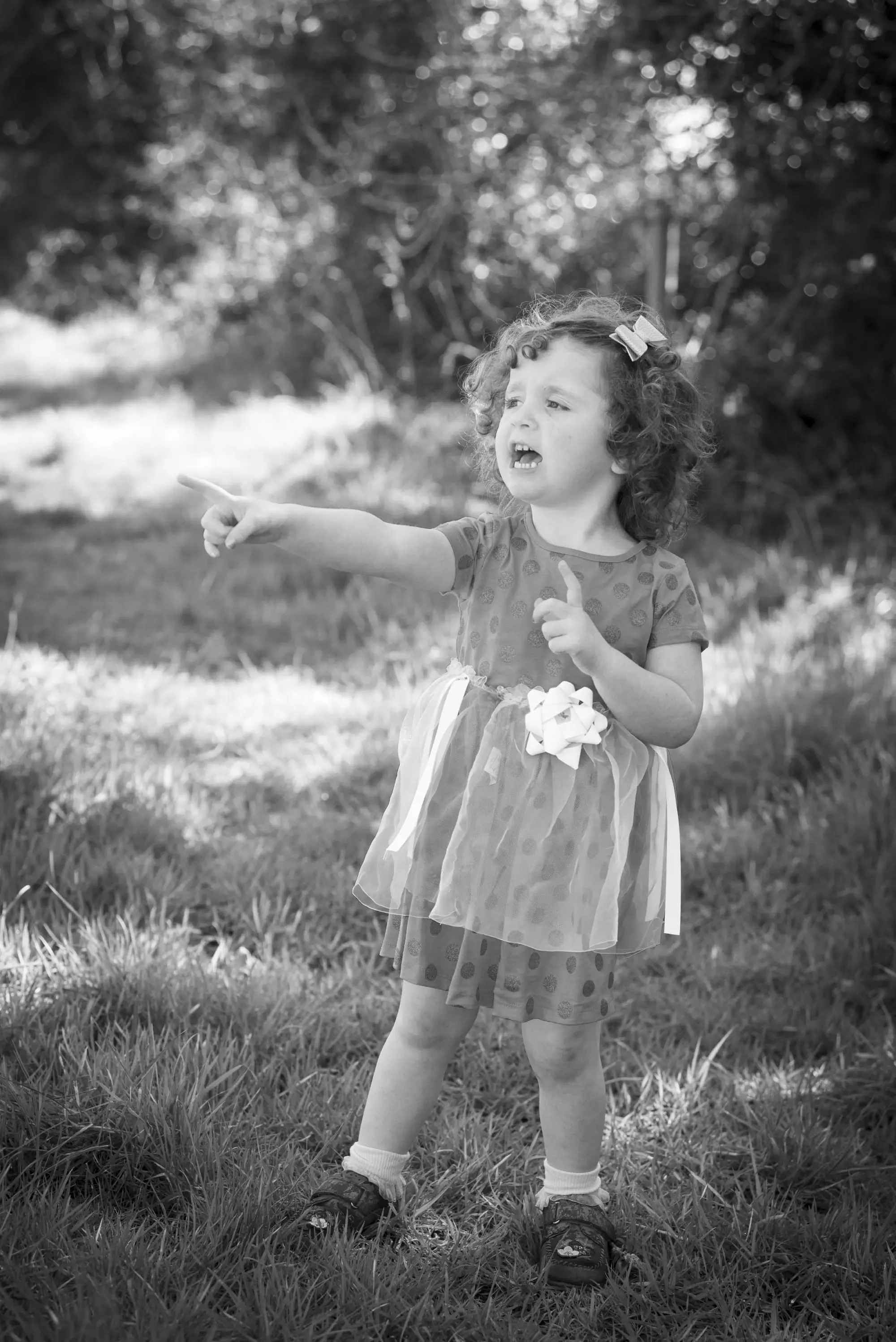 Little girl in black and white pointing